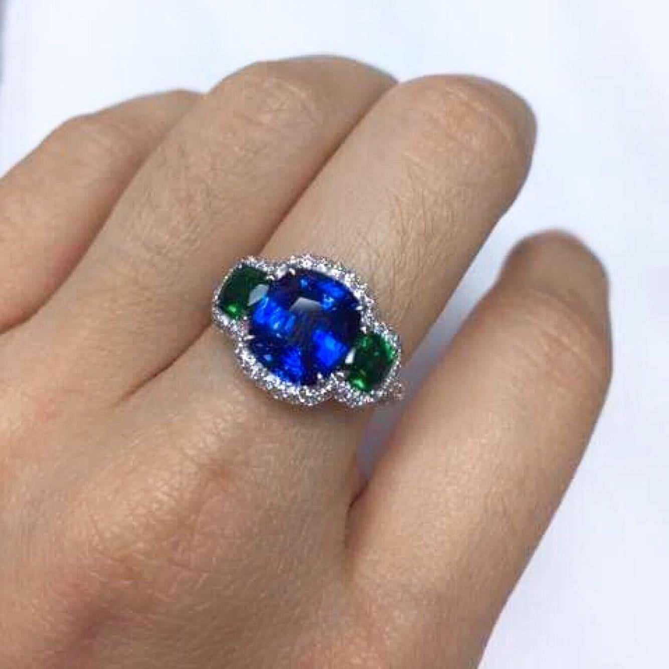 Wow! We handmade this one-of-a-kind sapphire emerald diamond ring.
 
18kt white gold set with sapphire Vivid Blue Sapphire, the emerald Vivid Green AAA quality.
 
E color VVS1: diamond 
Approx Total Carat Weight: 5.00cts
If you would like to see a