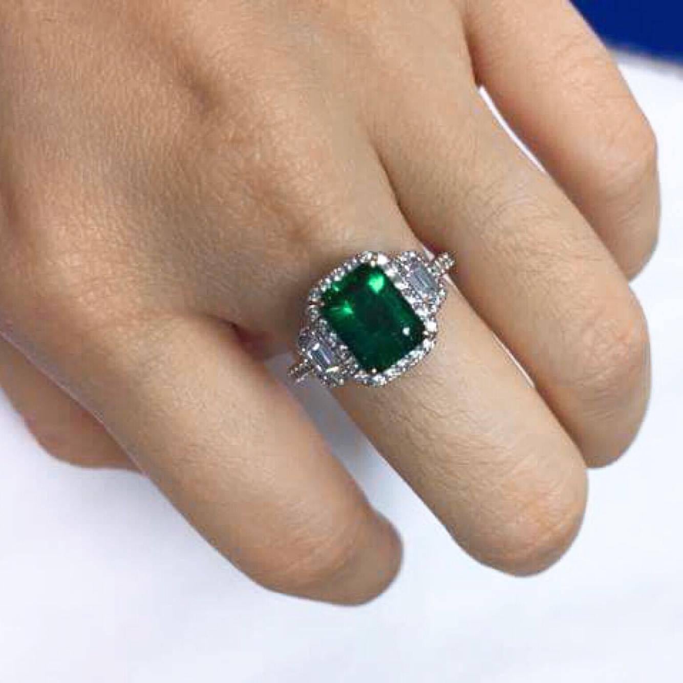 Certified Intense Green Emerald Diamond ring. The
Emerald:2.10ct
Side Diamonds E VVS1 Clarity=0.81ct

You will rarely find an emerald of this caliber, if you want the rarest you have found it! 