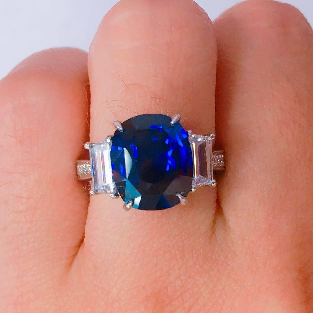 Set in Platinum this ring is sure to make any cloudy day a sunny one with Blue skies! Gorgeous center sapphire is full of life, has a gorgeous deep royal blue color to it, and the diamonds are all E color Vvs1 clarity. 
We will size this ring at no