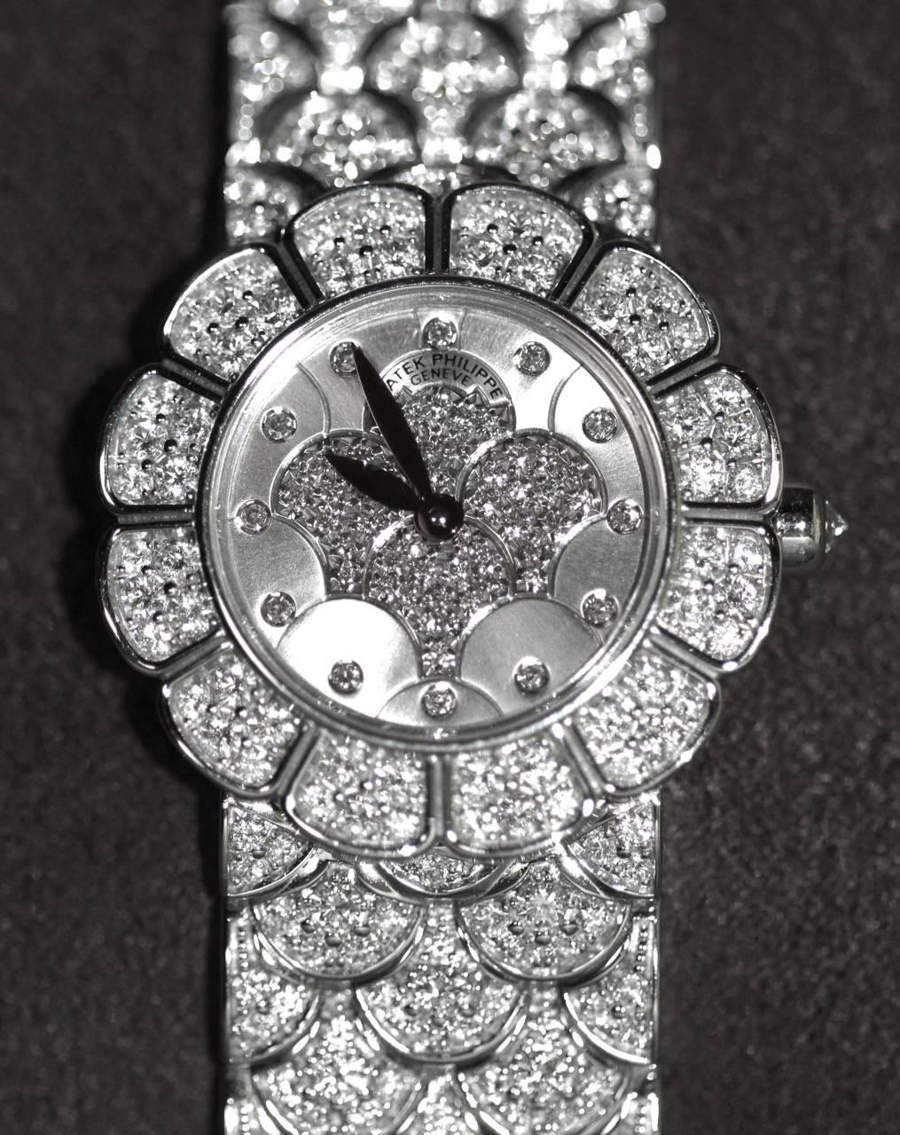 Stunning pre-owned Patek Philippe Ladies Watch. 
Barely worn, the watch is like new.

Ref: 4872/2G-001
Caliber: E-15 Quartz 
Movement Jewels: 6R
Case and dial set with 202 diamonds: 2.28 Ct
Dial: Pavé-set diamond bezel in the form of petals
Case:
