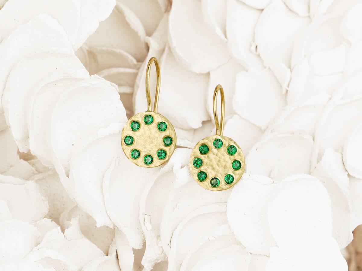 Sundial Tsavorite Earrings
Playing off each other delightfully, 18 karat hammered reclaimed gold and a total of 16, 2 mm ultra brilliant Bridges Tsavorite gems are featured together in these french hook earrings. 

Dimensions

Each disc is 1.1 cm