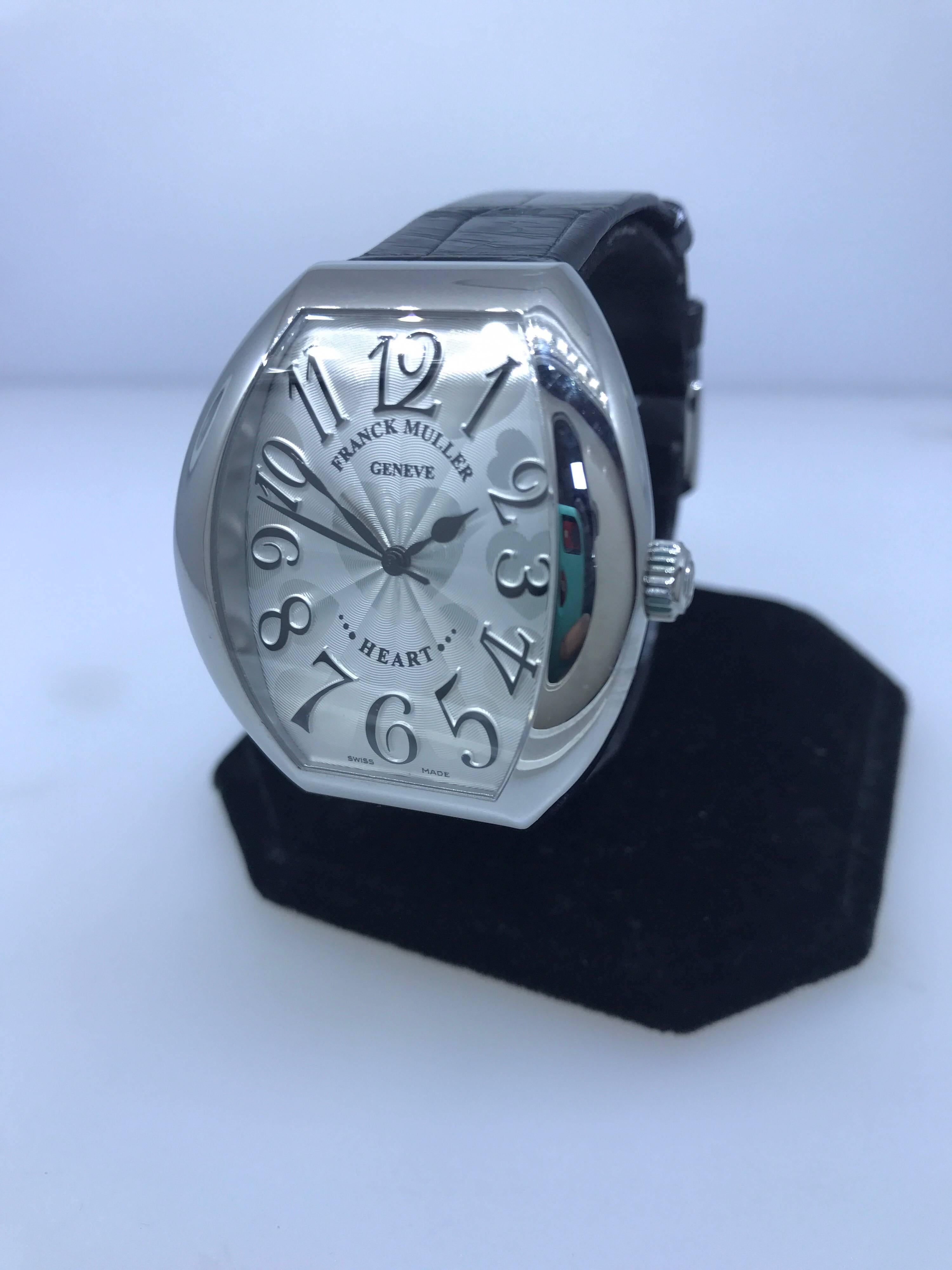 Franck Muller Tonneau Shaped Watch 

Model Number: 5000HSC

100% Authentic

New / Old Stock 

Comes with original Franck Muller box

Stainless Steel Case

Silver Dial with Hearts Motif

Case Dimensions: 34mm x 39.5mm

Black Crocodile Leather