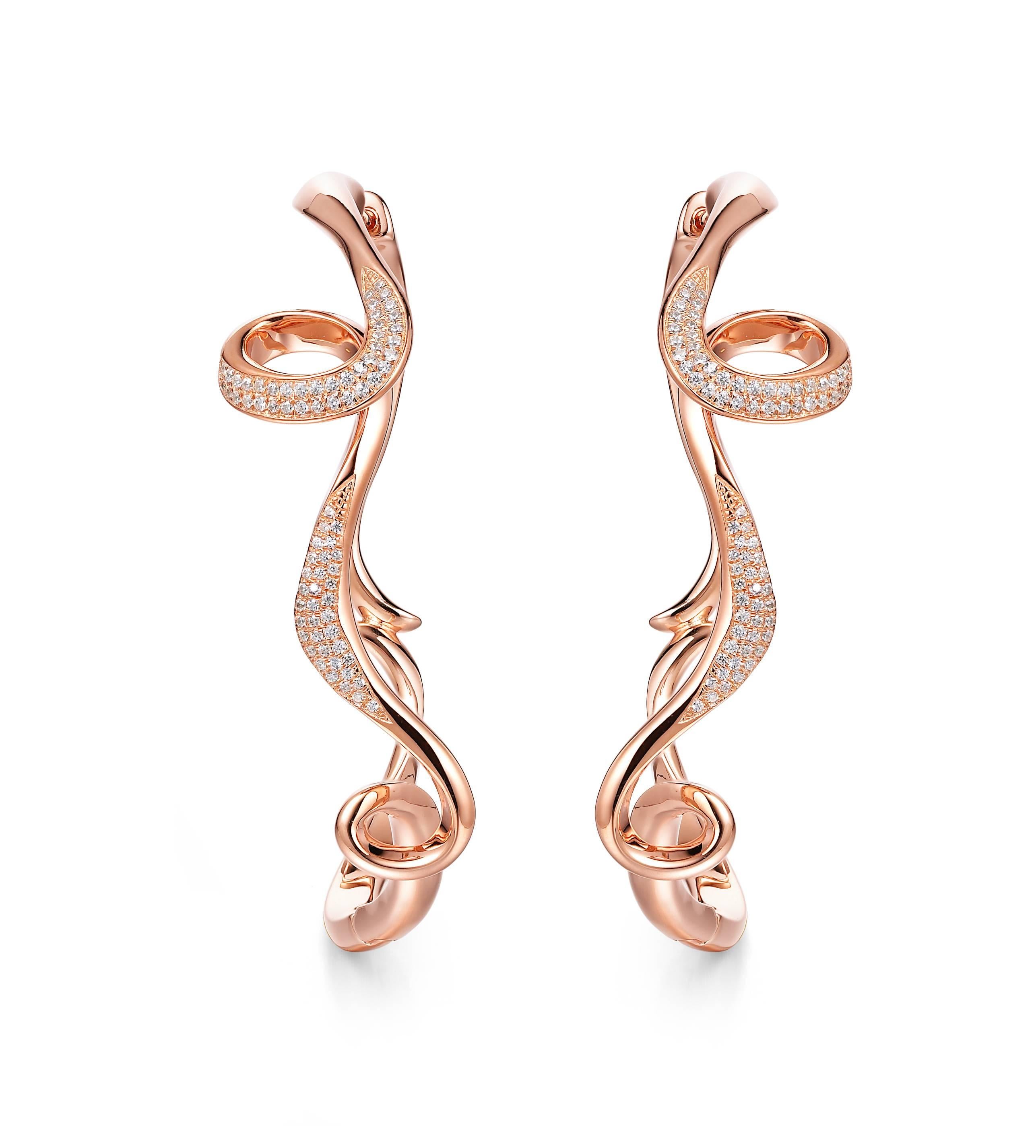 Description:
Serenity large hoops with white cubic zirconia, set in 18ct rose gold plate on sterling silver.

Inspiration:
Serenity is a collection in sterling silver, inspired by the flow and curves of the smoke of incense. Promoting a calm and