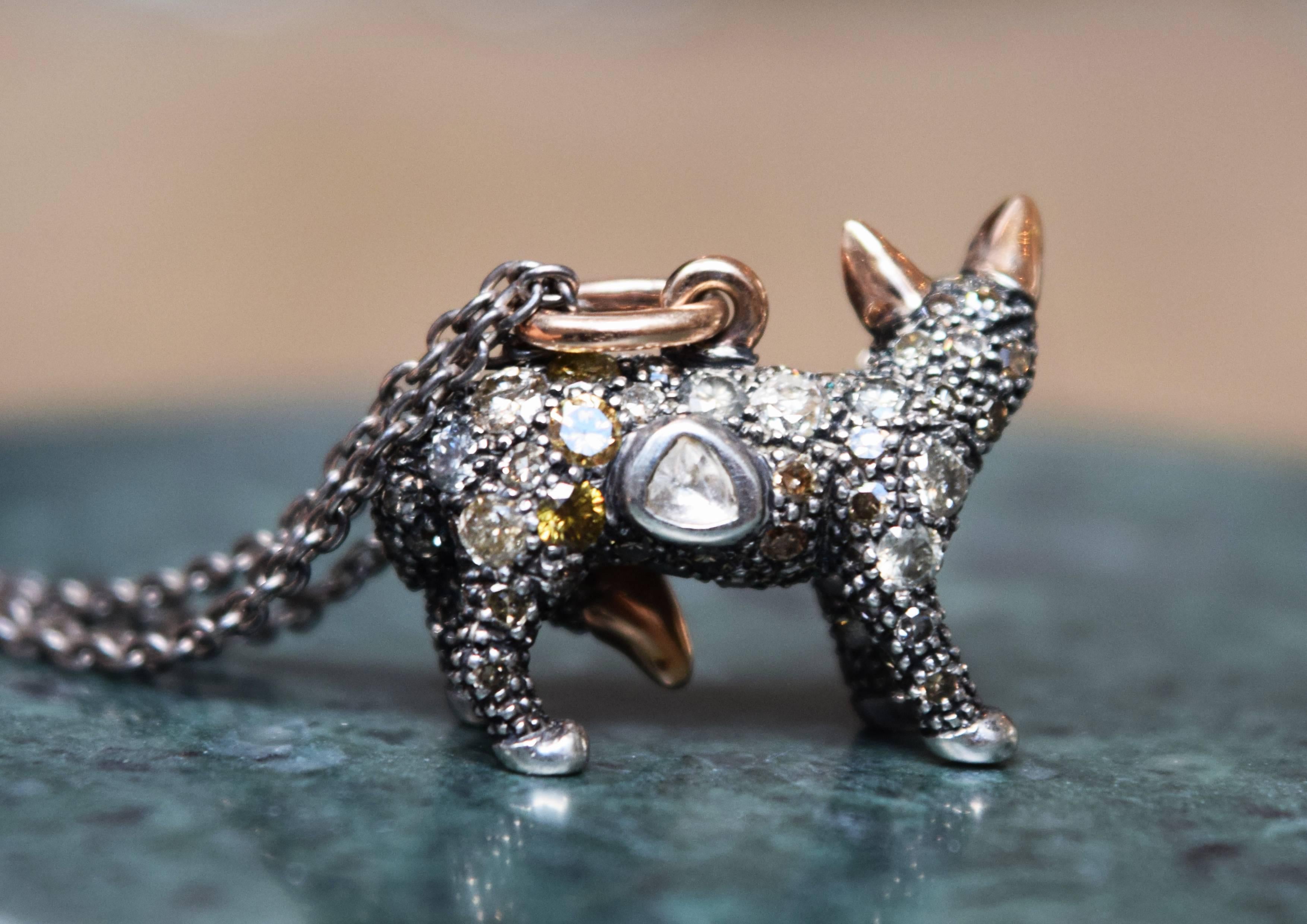The Fox Necklace, by Bibi van der Velden, is made of Sterling Silver fully-set with light brown diamonds, with Blue Sapphire eyes, polky diamonds and 18k rose gold accents. It includes a Sterling Silver double chain, of 70cm length that is