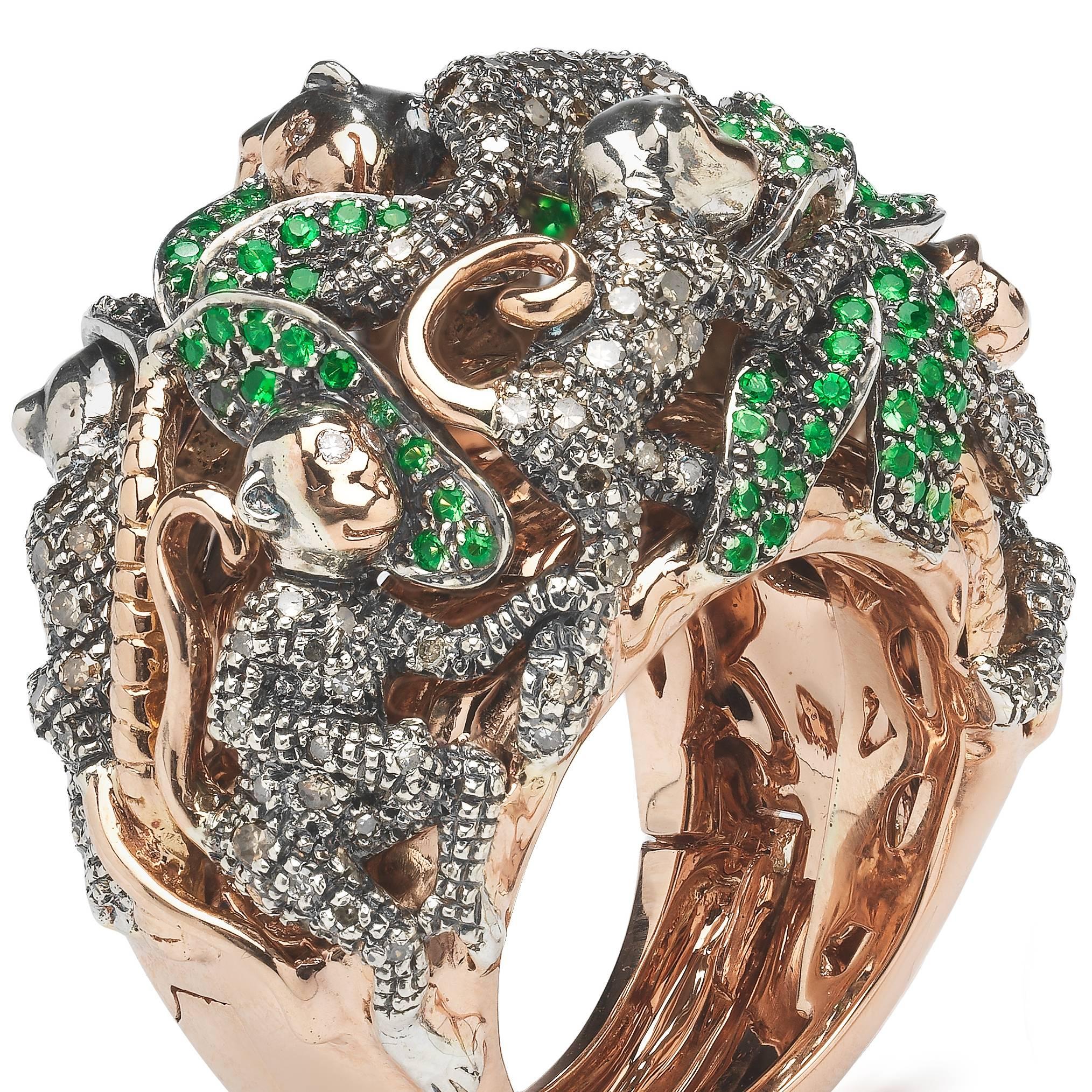 The Monkey Ring-in-a-Ring is a statement ring by Bibi van der Velden, using a technique she developed that allows you to open the bottom of the bigger ring to remove a smaller ring inside. The big ring, depicting playful monkeys and palm trees, is
