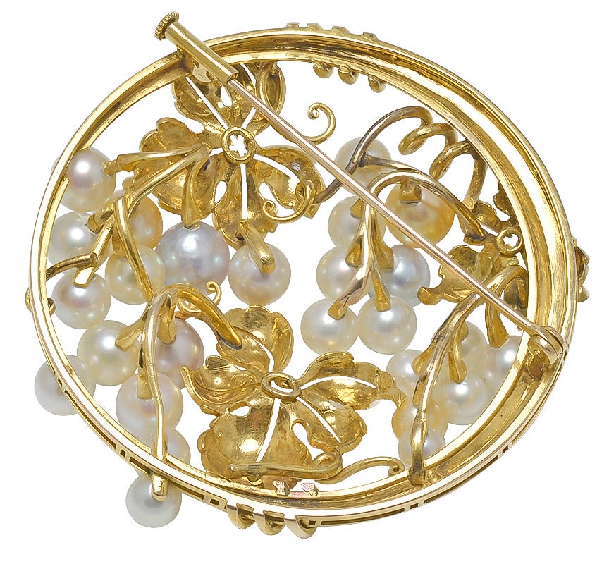 Large estate pin, Vine and Grape motif. Made and signed by Mikimoto. 
Set in 14k gold.
Most attractive and unusual. 2 inch dia.