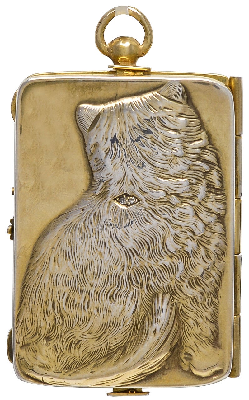 Antique sterling silver necessaire, showing figural cat in high relief on front; 
back shows back of cat. Ruby eyes; diamond collar with ruby.
2