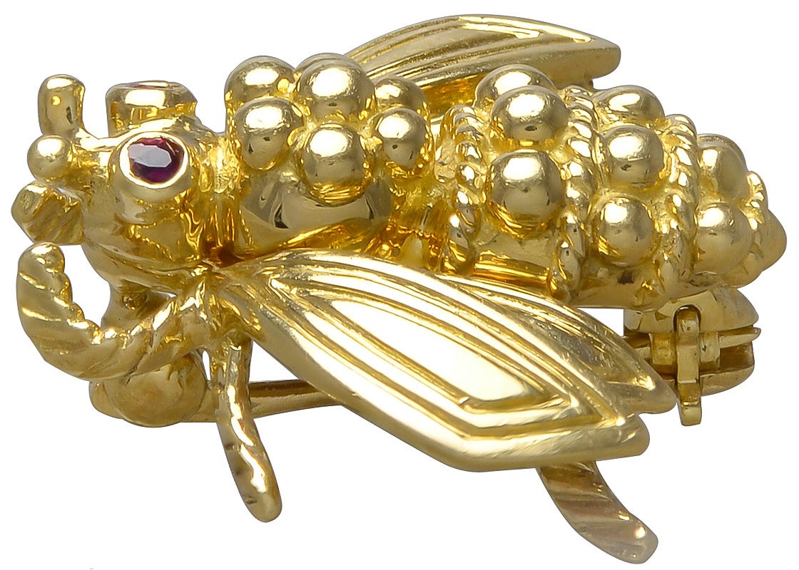 Very pretty 18K yellow gold figural bee pin. Made and signed by Tiffany & Co. Faceted ruby eyes. 3/4