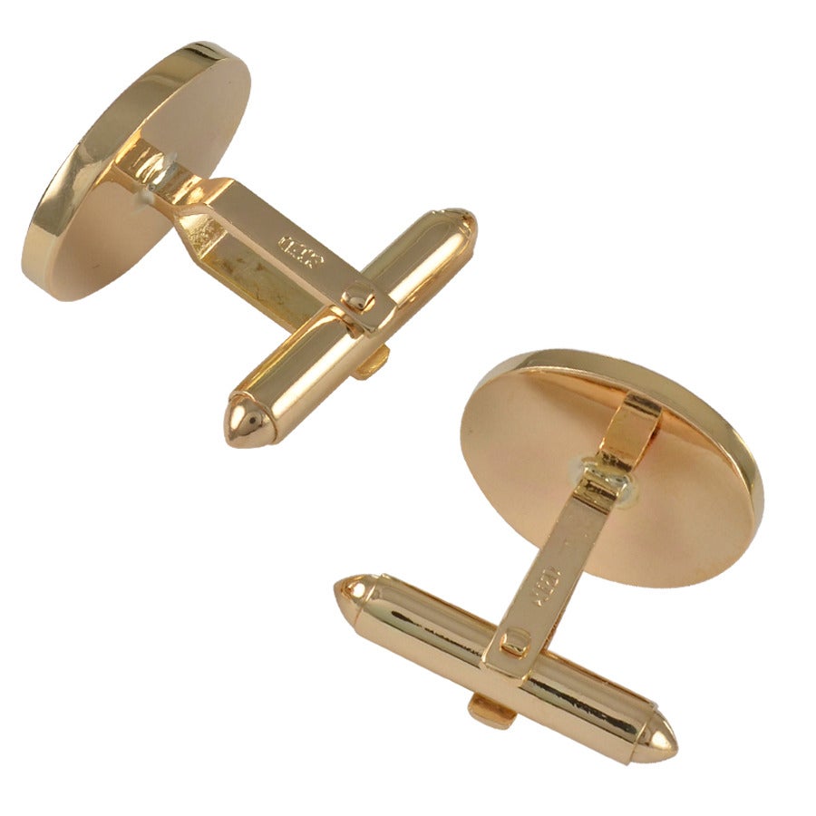 Oval cufflinks, set with lapis and onyx in 14K yellow gold.  An unusual style combination.

Alice Kwartler has sold the finest antique gold and diamond jewelry and silver for over 40 years. Come and visit our magnificent store at 445 Park Avenue