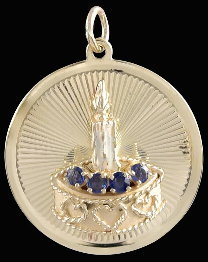 Lovely 14K yellow gold charm, by DANKNER & SONS, New York.  A round disc, with an applied birthday cake, with hearts decorating the cake, set with faceted sapphires and an enamel candle.  1