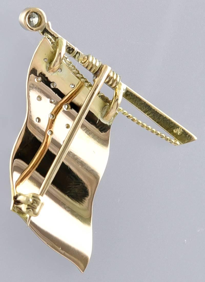 Beautiful figural American Flag pin.  14K yellow gold, set with 13 diamonds, with red, white and blue enamel.  1