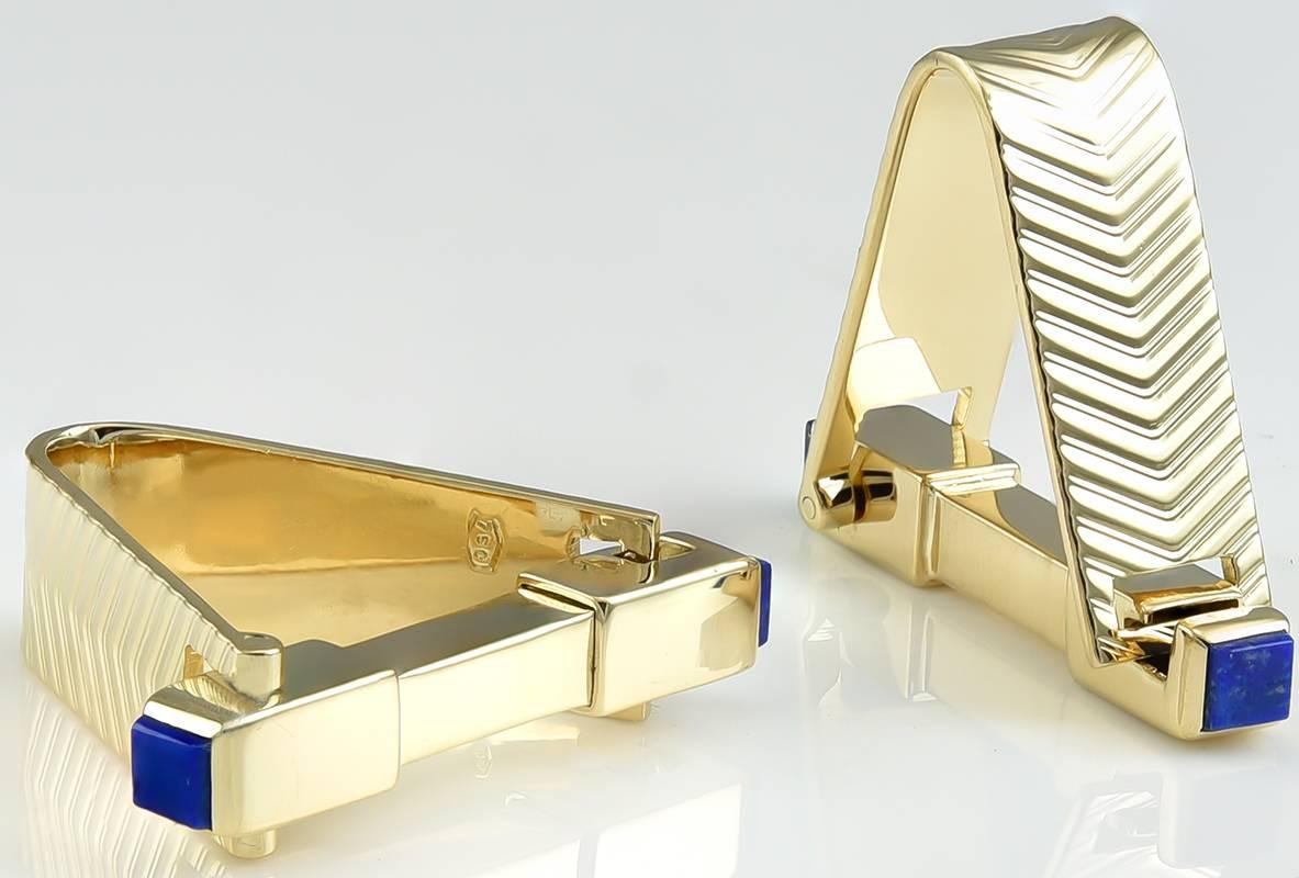 Large cufflinks that go through and around the cuff.  Solid 18K yellow gold, with engraved chevron pattern.  Set with squares of lapis on each end.  Spring loaded hinge.  1