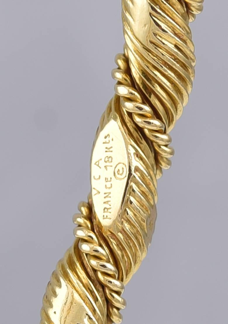 Elegant bangle bracelet.  Made and signed by VAN CLEEF & ARPELS FRANCE.  Rope twist pattern, with applied gold threading. 18K yellow gold. Size medium to large.  Lovely on its own or paired with another bracelet or watch.

Alice Kwartler has sold