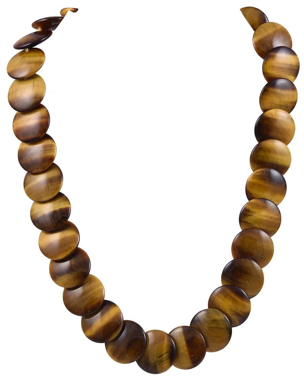 Luminous necklace.  Signed Paloma Picasso TIFFANY & CO.   Highly polished round tiger eye discs.  Gleaming tones of brown and beige.   18K yellow gold.  18