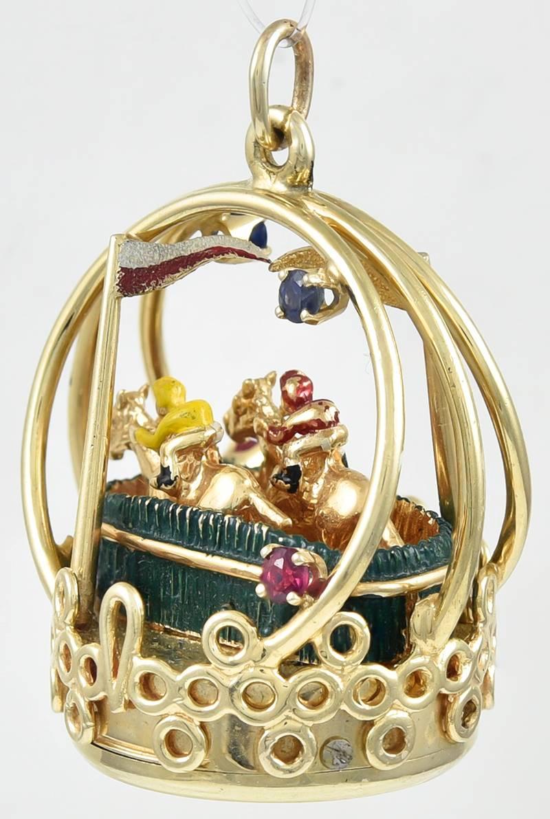 Great large figural horse racing charm.  Made and signed by DANKNER.  14K yellow gold and enamel, with sapphires and rubies.  The charm winds up -- and the horses start running!  1 1/4