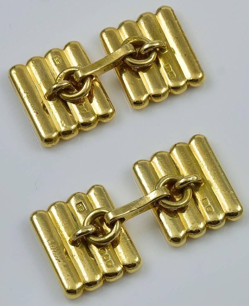  Classic 18K yellow gold cufflinks.  Made and signed by CARTIER.  Double-sided, with deep ribbed  pattern on all four sides.  1/2
