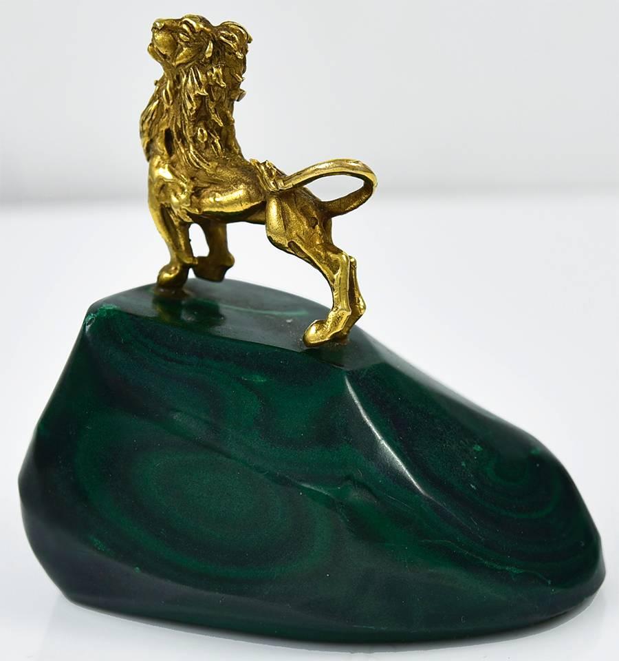 Figural 14K gold lion surveying his territory.  Head held high, tail raised.  On a faceted malachite 