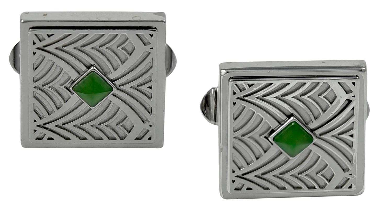 Very original pair of cufflinks.  Made, signed and numbered by CARTIER.  Sterling silver, with an exotic design; set with a diamond-shaped piece of nephrite.  Front and bar are sterling; the flip bar is metal.  2/3