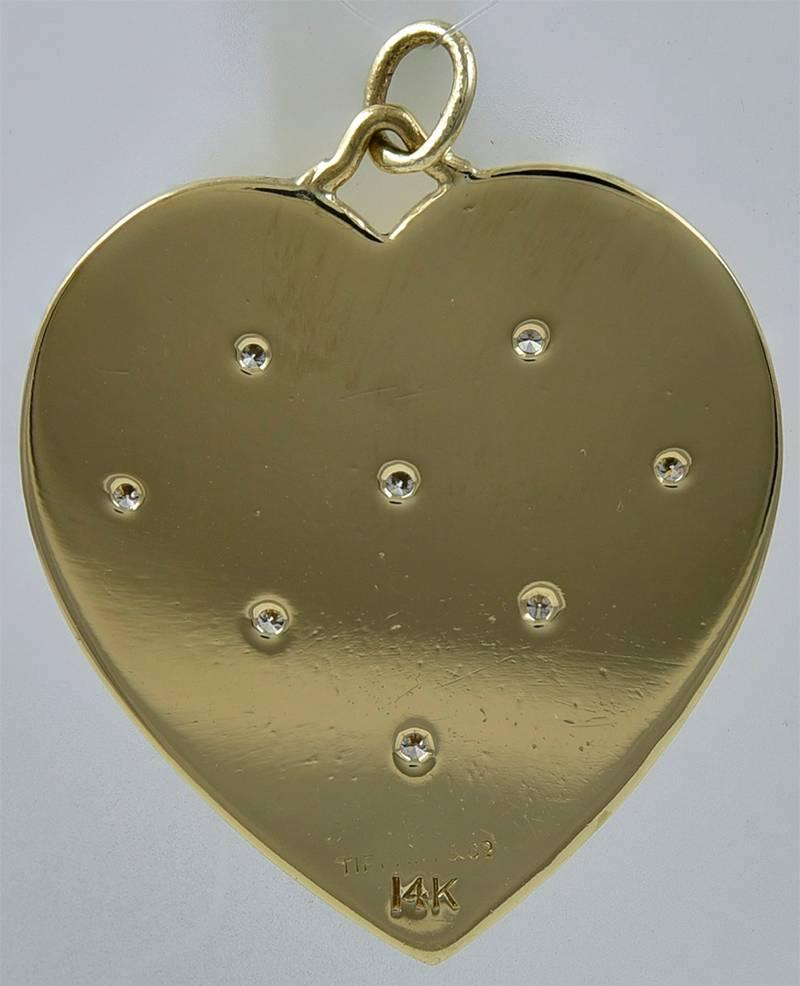 Large beautiful figural heart charm/pendant.  Made and signed by TIFFANY & CO.  14K yellow gold.  Fine-line engraved alternating textured squares, set off with eight faceted diamonds.  1 1/4