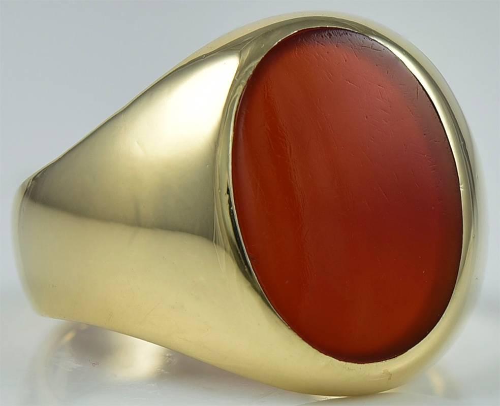 Handsome men's signet ring.  Made and signed by TIFFANY & CO.  Heavy gauge 14K yellow gold mounting, set with a large oval carnelian.  Size 12 1/2 and can be custom-sized.  Well made; a classic ring.

Alice Kwartler has sold the finest  antique