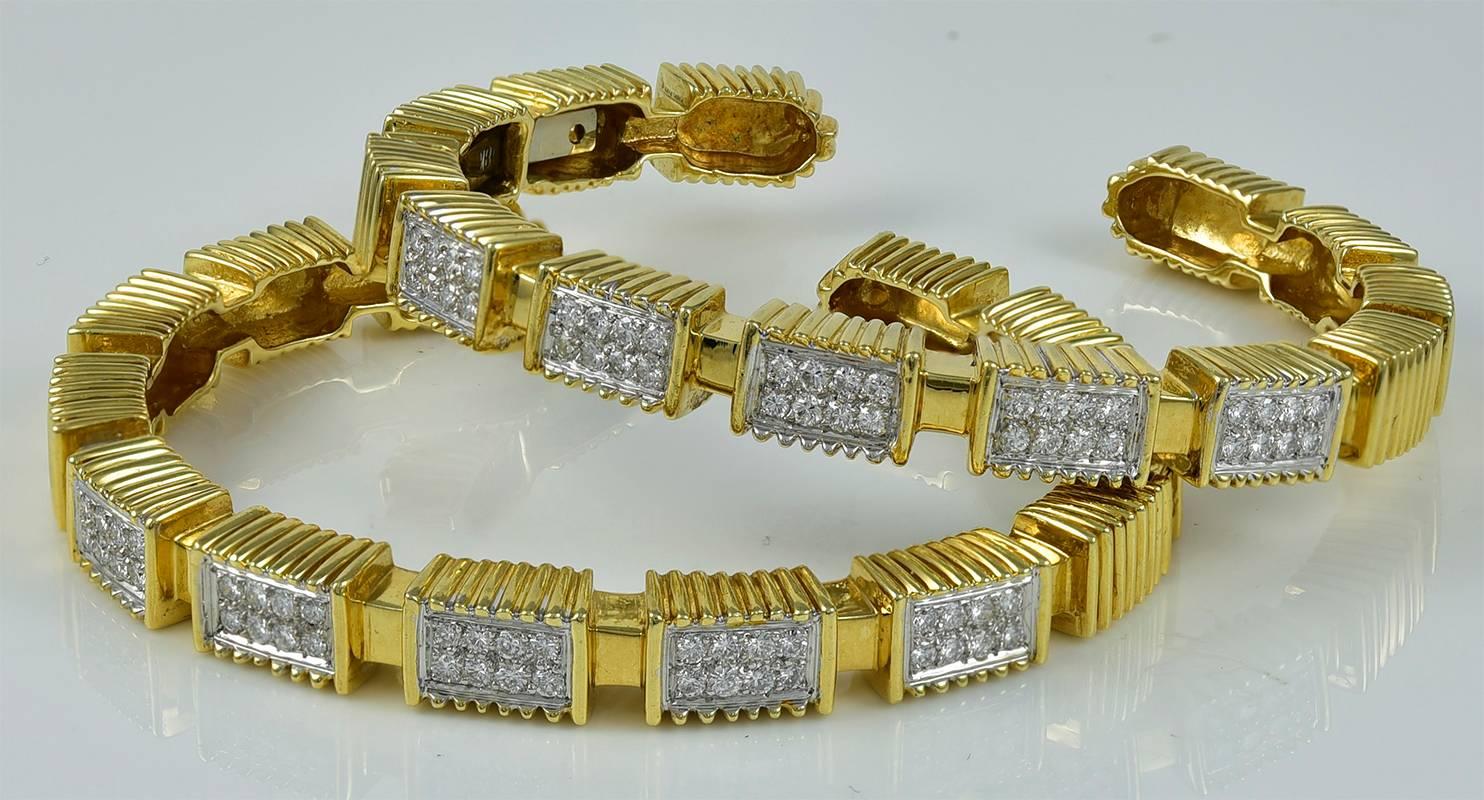 Striking pair of 18K yellow gold bracelets, set with 2.50 cts. of brilliant white diamonds in a geometric pattern.  Flip-up hinged closure.  So difficult to find pairs of bracelets; these are exceptional.

Alice Kwartler has sold the finest