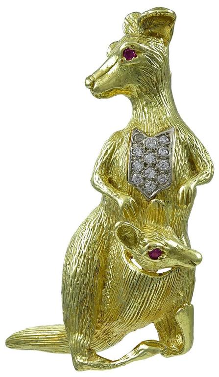 Figural brooch, a mother kangaroo carrying her baby in her pouch. 18K yellow gold, set with bright faceted rubies and diamonds.  2 1/4