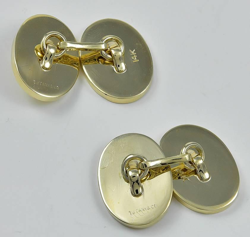 Elegant double-sided cufflinks.  Made and signed by TIFFANY & CO.  Alternating panels of shiny and engine-turned 14K yellow gold.  Very solid, heavy gauge.  3/4