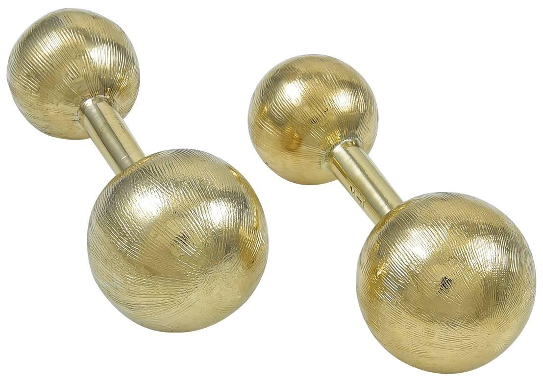 Classic barbell cufflinks.  Made, signed and numbered by CARTIER.  14K yellow gold, with a mellow satin finish.  Easy to put on and right for any occasion.

Alice Kwartler has sold the finest antique gold and diamond jewelry and silver for over