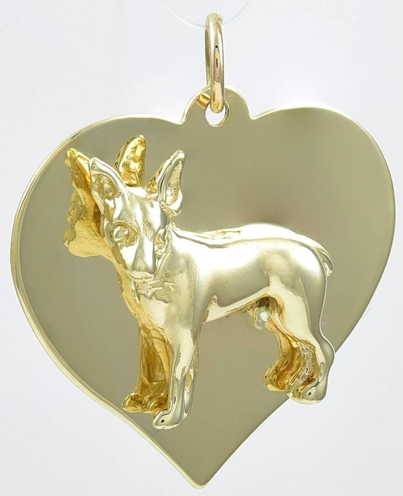 Unusual and endearing charm:  a figural chihuahua  applied on a gold heart.  
14K yellow gold,  1
