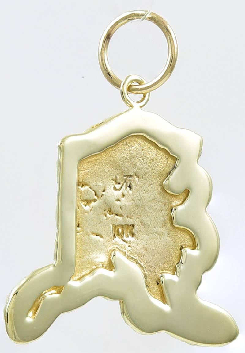 Figural "Alaska" charm.  Textured map, with an applied "49."   1" x 3/4." 
10K yellow gold.  Intricate detail that looks three-dimensional.

Alice Kwartler has sold the finest antique gold and diamond jewelry and silver