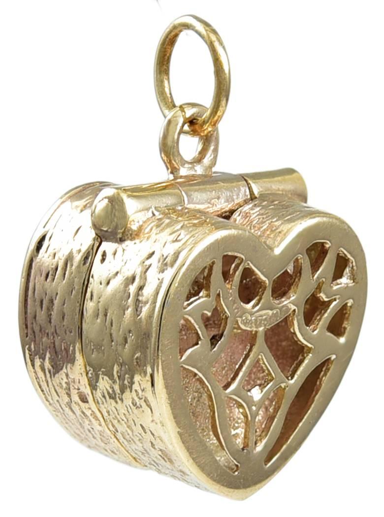 Figural heart openwork hinged charm.  Opens to reveal a diamond engagement ring.  14K yellow gold.  1/2" x 1/2" x 1/3."  A lovely addition to a "life experience" bracelet.

Alice Kwartler has sold the finest antique gold