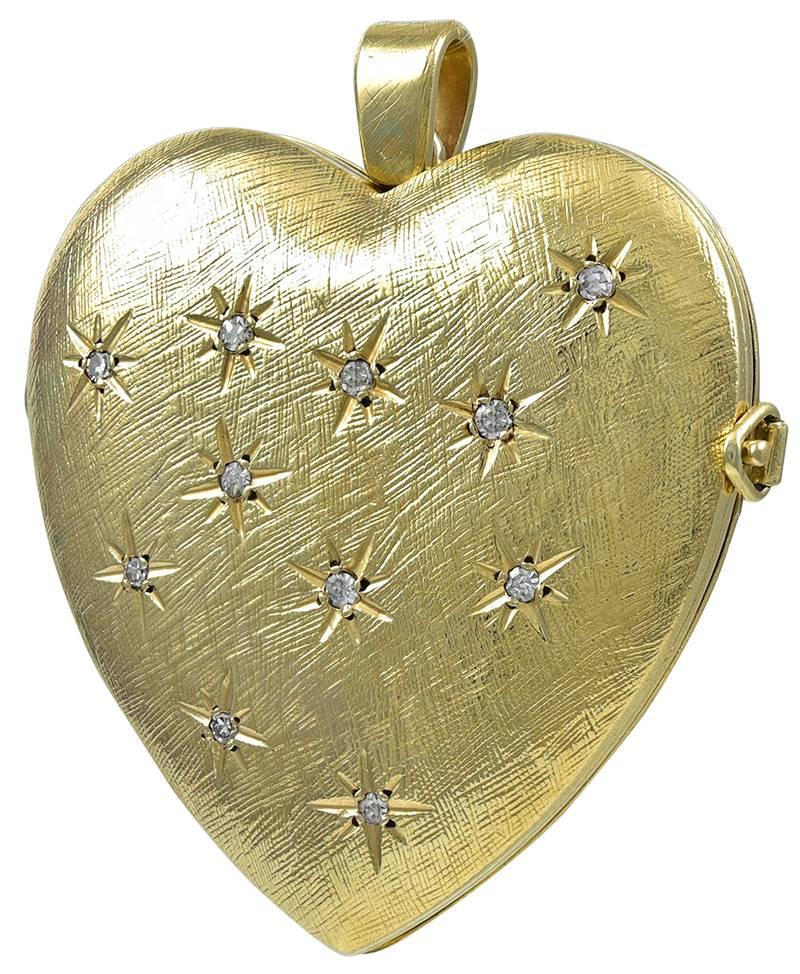 Extra large figural "heart" locket.  Set with eleven faceted diamonds, in a radiant star pattern.   Heavy gauge 14K textured yellow gold, with a shiny gold back.  Opens to hold two pictures, with original bezels.  1 3/4" x 1