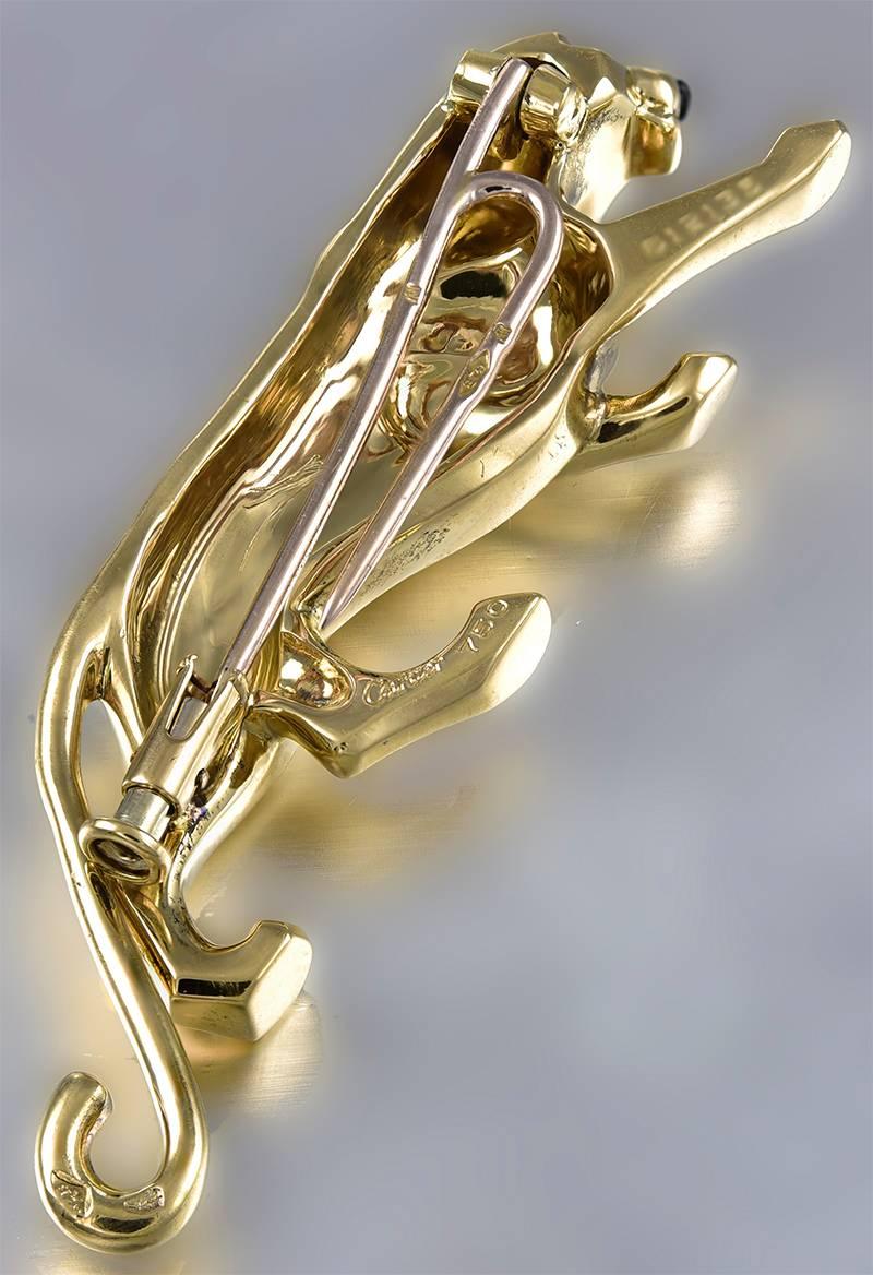 Figural "Panther" clip.  Made, signed and numbered by CARTIER Paris. 18K yellow gold with bright emerald eyes.  2 1/4" x 1/2."  An elegant feline.

Alice Kwartler has sold the finest antique gold and diamond jewelry and silver