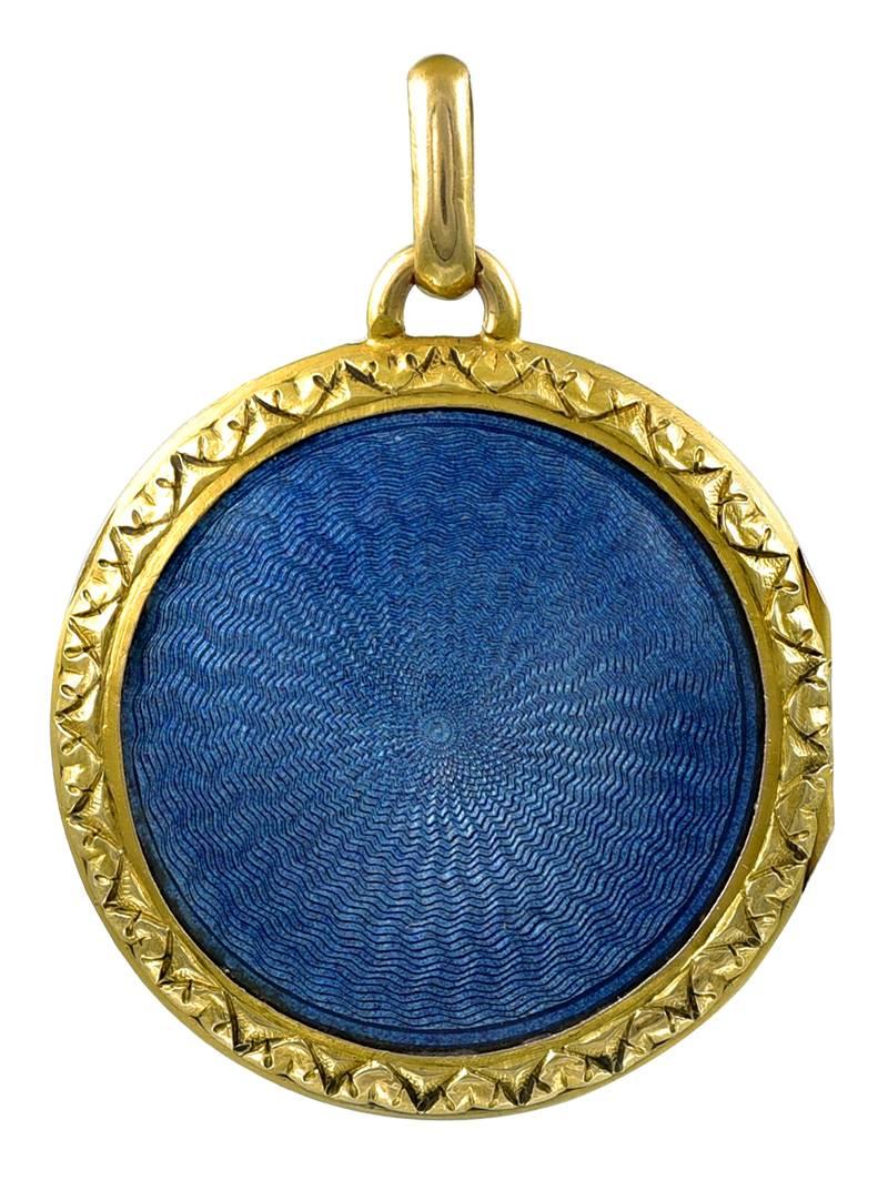 Exquisite antique locket, with double-sided french blue guilloche enamel.  18K yellow gold.  On the front is a beautiful basket of flowers, tied with a ribbon.  Intricate engraved border front and back.  1 1/8" in diameter.

Alice Kwartler has