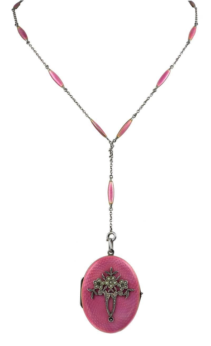 Absolutely exquisite sterling silver and guilloche enamel locket.  Luminous pink coloring, front and back.  Set with seed pearls and marcasites.  On original pink enamel and sterling 25