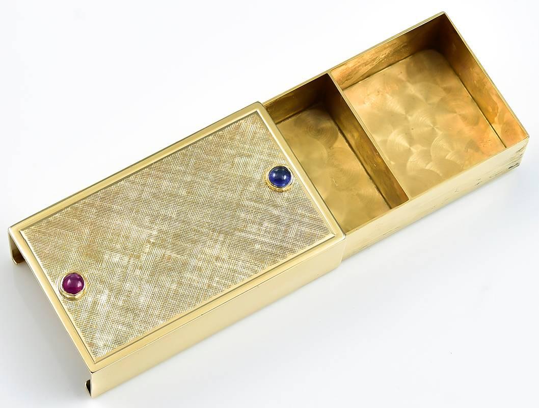 Attractive double-sided pill box.  Set with a ruby and a sapphire, to facilitate the sliding mechanism.  14K textured yellow gold.  3/4