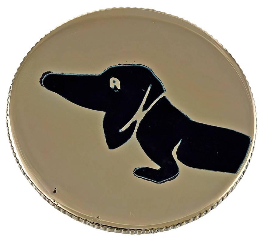 Fabulous figural "dachshund" head or tail coin.  The dog's head, in black enamel, is on the front of the coin, and the tail is on the reverse.  Coin cut border.  14K yellow gold.  1 1/8" in diameter.  14K yellow gold.  A great