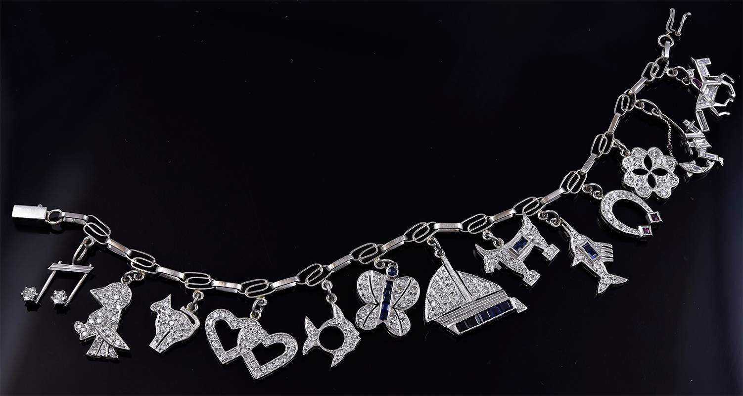 One-of-a-kind antique platinum charm bracelet.  Set with thirteen platinum charms: one is prettier than the next!  (Most unusual because these bracelets usually have some undistinguished charms.)  The charms are encrusted with diamonds, rubies and