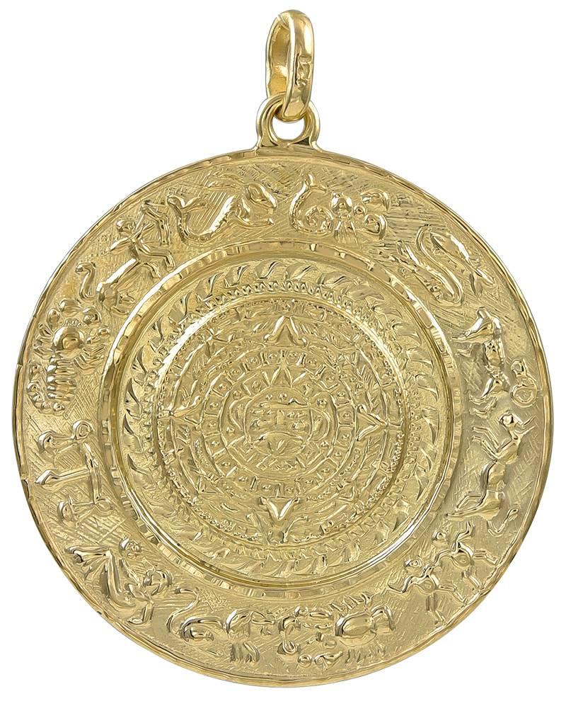Leo zodiac charm/pendant.  14K yellow gold. Figural  Leo in center, applied on a textured gold background, with scattered engraved stars. Embossed border.  Reverse side shows all the zodiac signs.  1 1/4 in diameter.

Alice Kwartler has sold the