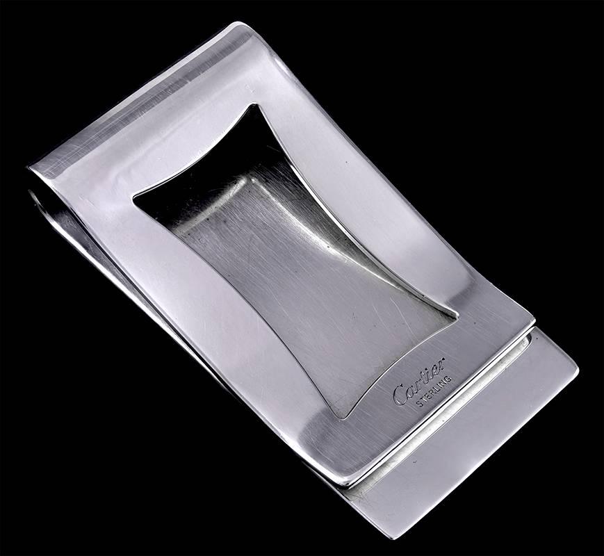 Sterling silver money clip.  Made and signed by CARTIER.  Engine-turned lines, the Cartier logo, and a reserve for monogramming.  2" x 1"  

Alice Kwartler has sold the finest antique gold and diamond jewelry and silver for over forty