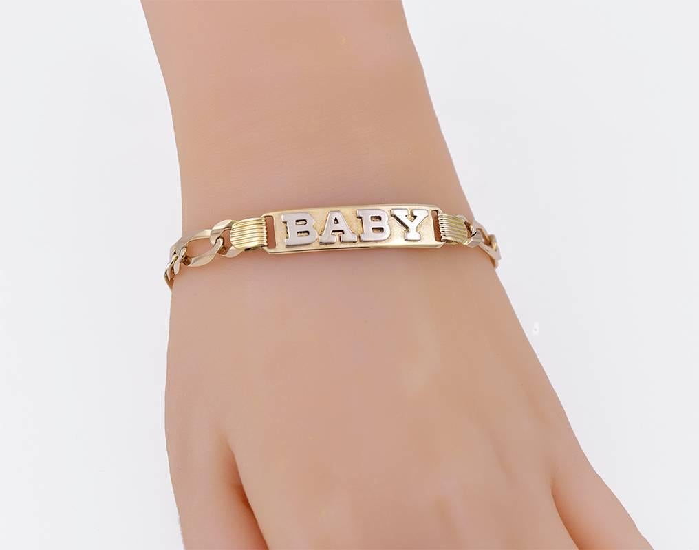 Slim and silky ID link bracelet, with applied letters:  "BABY." 14K yellow gold.  6 3/4" long.  For the "BABY" in your life.

Alice Kwartler has sold the finest antique gold and diamond jewelry and silver for over forty