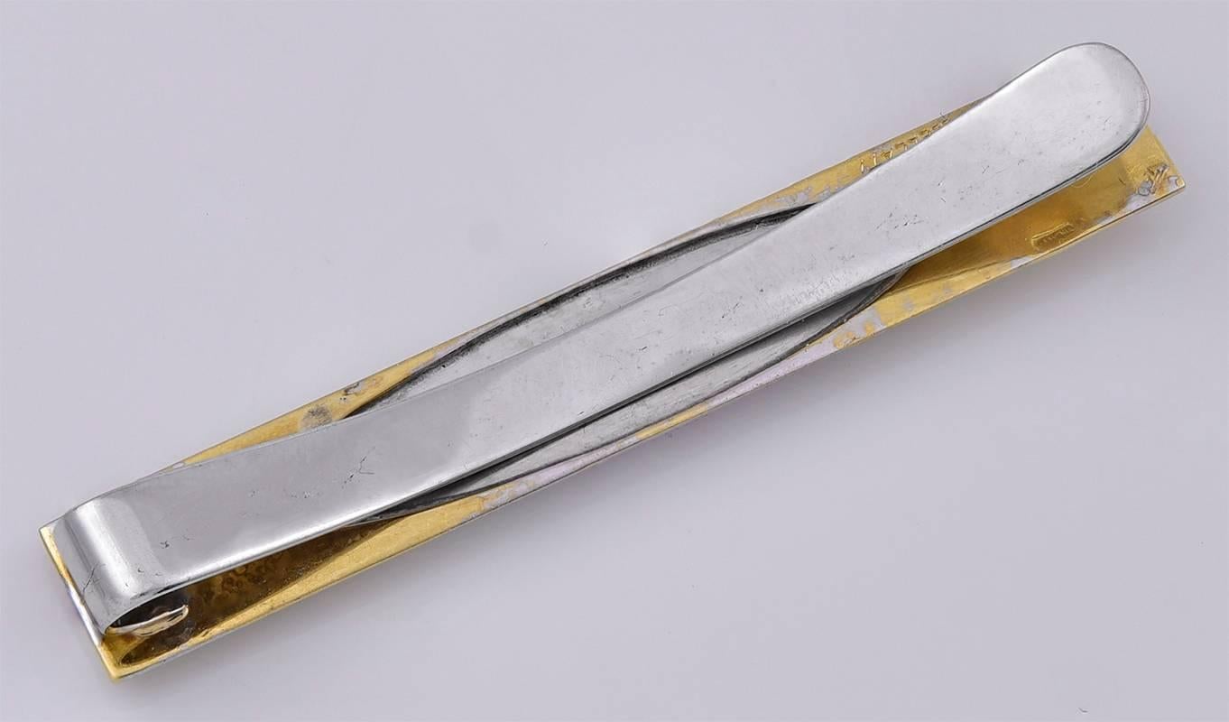 Beautiful and unusual barrette.  Made and signed by MARIO BUCCELLATI.  18K yellow gold, with an applied white gold cartouche and then a smaller reserve of yellow gold. All with the typical fine Buccellati patina.  2 1/8" long.

Alice Kwartler