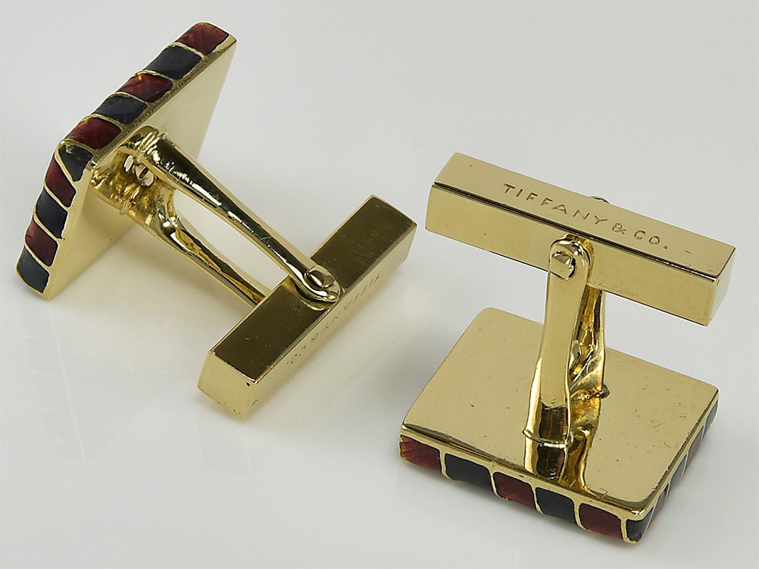 Handsome rectangular cufflinks.  Made and signed by Tiffany & Co.  Heavy gauge 18K gold with crisp red and charcoal gray enamel diagonal stripes.  A distinctive cufflink.

Alice Kwartler has sold the finest antique gold and diamond jewelry and