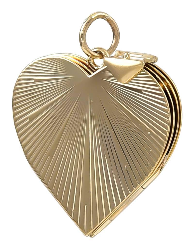 Figural "heart" locket.  14K yellow gold, with radiating line pattern.  Opens to reveal space for six paste-on pictures.  1 1/8" x 1 1/8."  Solid gauge gold.

Alice Kwartler has sold the finest antique gold and diamond jewelry