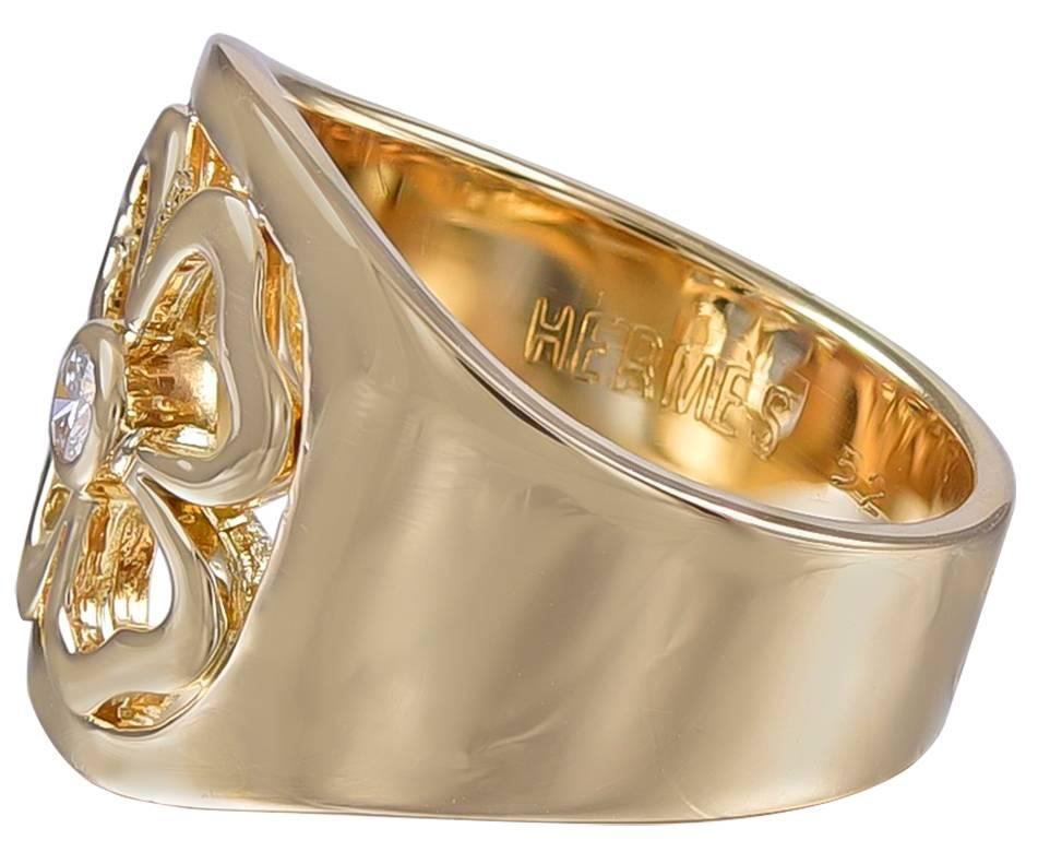 Unique and most attractive ring.  Made,  signed and numbered by HERMES.
18K yellow gold solid band with a cut-out four-leaf-clover on the top.  Centered with a bezel-set faceted diamond.  European size 52; American size 6.  

Alice Kwartler has sold