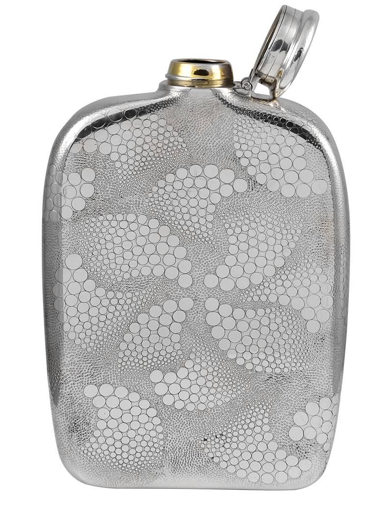 Outstanding sterling silver flask.  Made and signed by TIFFANY & CO.  Allover finely stippled background, superimposed with an applied circle swirl design, front and back.  In the Japanese style.  5" x 7."  Marked "Tiffany &