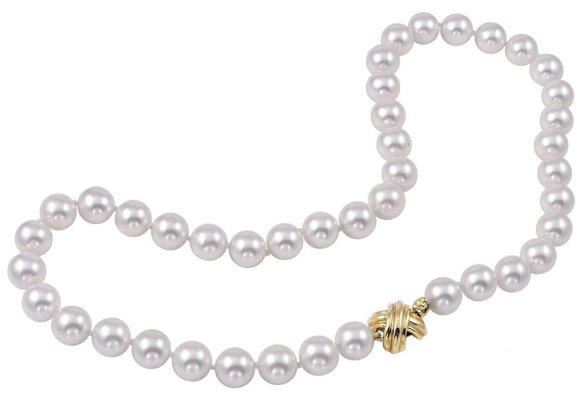 Timeless pearl necklace.  Made and signed by TIFFANY & CO.  18K gold "X" clasp.  17” long.  8.5 mm.  Lustrous pearls.  A classic iconic look for day or night.

Alice Kwartler has sold the finest antique gold and diamond jewelry and