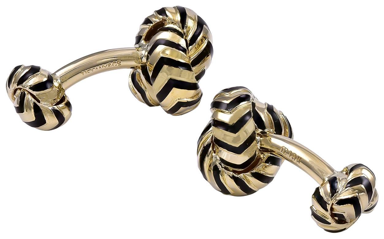 Figural "knot" cufflinks.  Made and signed by TIFFANY & CO.  Very heavy gauge 18K yellow gold, with black enamel detailing.   Easy to put on.  A strong masculine look.

Alice Kwartler has sold the finest antique gold and diamond