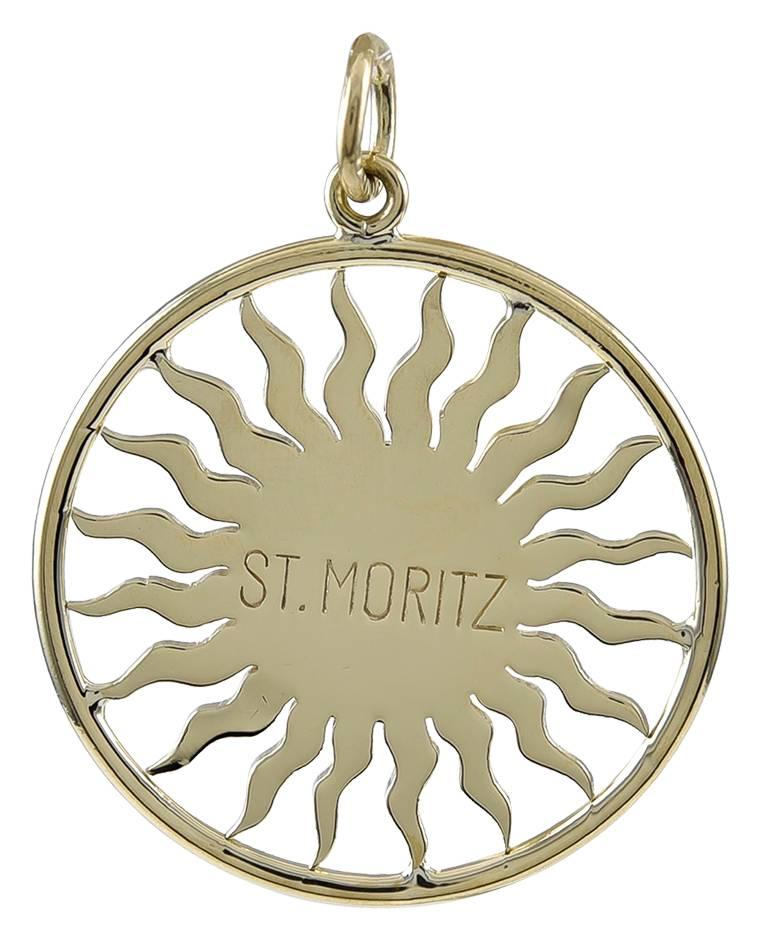 Cheerful St. Moritz "sun face" charm.  18K yellow gold.  1" in diameter.  "St. Moritz" is engraved on the reverse side.  A lovely memento.

Alice Kwartler has sold the finest antique gold and diamond jewelry and silver for