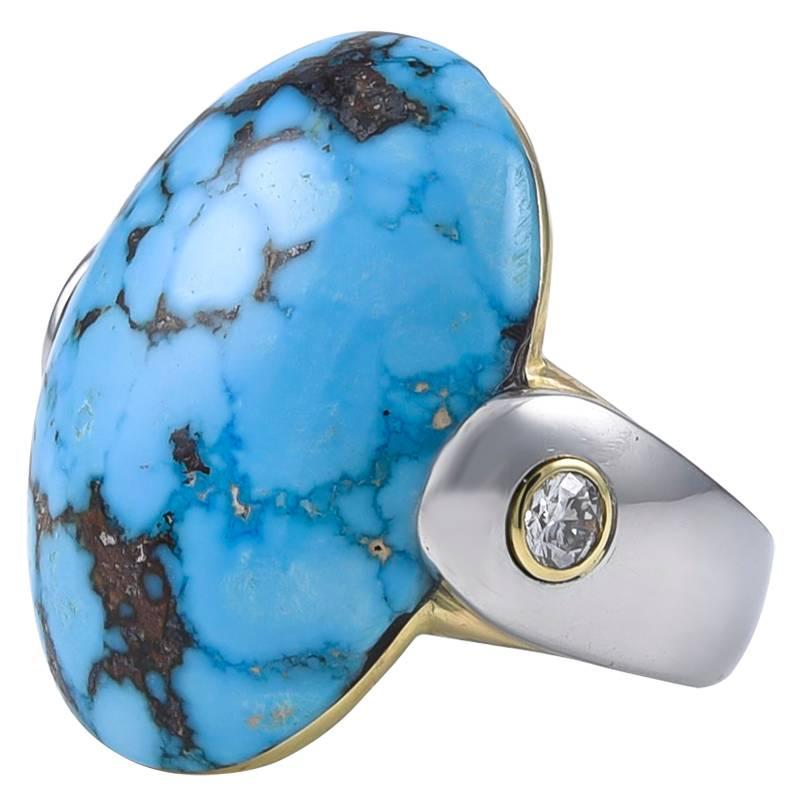 Big and beautiful oval turquoise ring.  The backing is 18K gold.  The band is heavy gauge platinum;  with an 18K bezel-set diamond on each side of the center stone (.50 ct).   The turquoise measures 25mm x 28mm.   A one-of-a-kind, most original
